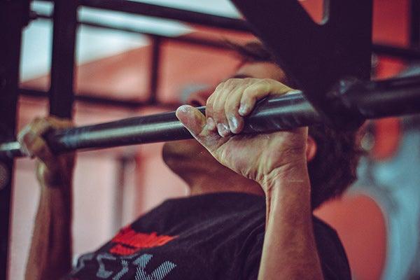 How to Stretch Your Lower Back with a Pull Up Bar - FitBeast